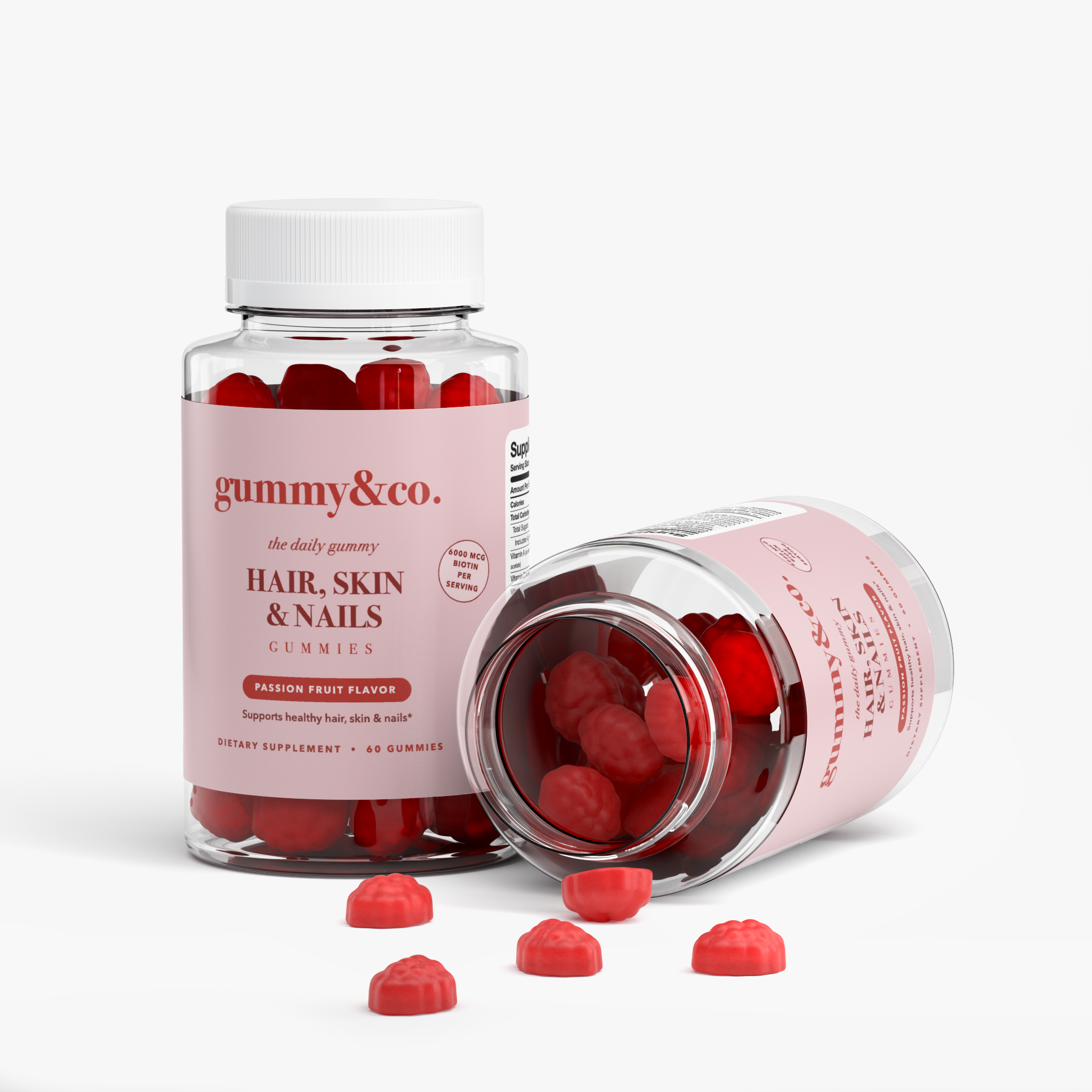 Two bottles of Hair, Skin & Nails Gummies, one open with red gummies spilling out